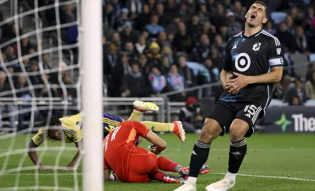 Minnesota United defender Michael Boxall (15) reacts after Real Salt Lake midfielder Emeka Eneli, left, scores a goal on United goalkeeper Dayne St. Clair, center, during the second half of a first-round soccer match of the MLS Cup playoffs in St. Paul, Minn., Saturday, Nov. 2, 2024. (AP Photo/Ellen Schmidt)