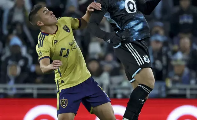 Minnesota United midfielder Hassani Dotson, right, gets a header over Real Salt Lake forward Cristian Arango (9) during the first half of a first-round soccer match of the MLS Cup playoffs in St. Paul, Minn., Saturday, Nov. 2, 2024. (AP Photo/Ellen Schmidt)