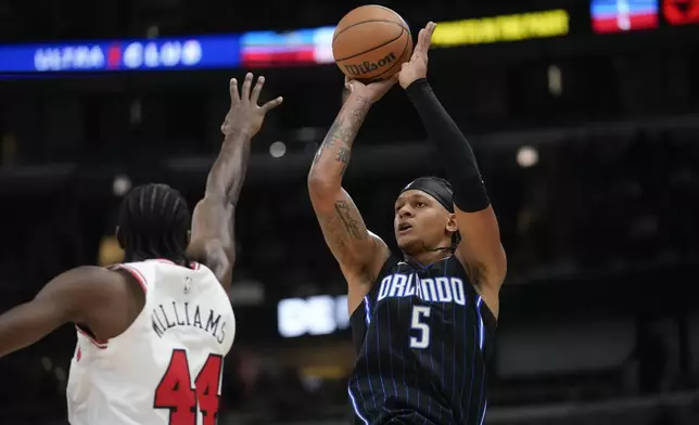 Orlando Magic forward Paolo Banchero shoots over Chicago Bulls forward Patrick Williams, left, during the first half of an NBA basketball game Wednesday, Oct. 30, 2024, in Chicago. (AP Photo/Erin Hooley)