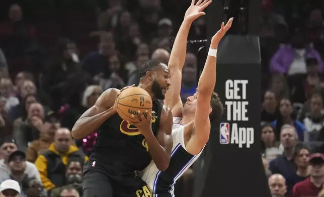 Cleveland Cavaliers forward Evan Mobley drives against Orlando Magic forward Franz Wagner, right, in the first half of an NBA game, Friday, Nov. 1, 2024, in Cleveland. (AP PhotoSue Ogrocki)