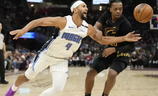 Orlando Magic guard Jalen Suggs (4) is fouled by Cleveland Cavaliers guard Darius Garland, right, in the first half of an NBA basketball game, Friday, Nov. 1, 2024, in Cleveland. (AP PhotoSue Ogrocki)