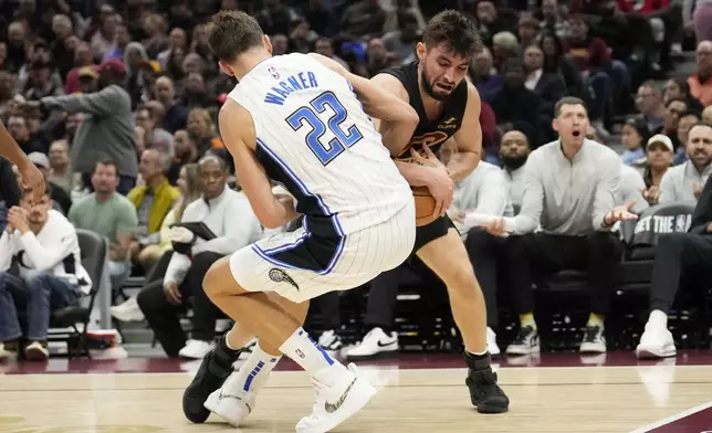 Cleveland Cavaliers guard Ty Jerome, right, takes the ball away from Orlando Magic forward Franz Wagner (22) in the first half of an NBA basketball game, Friday, Nov. 1, 2024, in Cleveland. (AP PhotoSue Ogrocki)