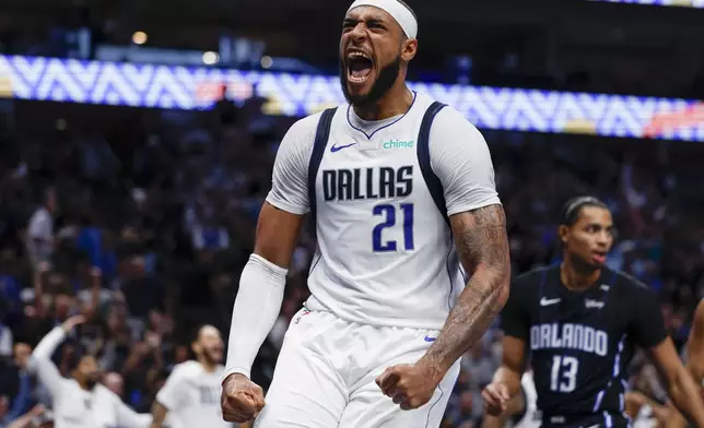 Dallas Mavericks center Daniel Gafford (21) celebrates after dunking during the first half of an NBA basketball game against the Orlando Magic, Sunday, Nov. 3, 2024, in Dallas. (AP Photo/Gareth Patterson)