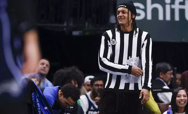 Orlando Magic forward Paolo Banchero stands by the bench during the second half of an NBA basketball game against the Dallas Mavericks, Sunday, Nov. 3, 2024, in Dallas. (AP Photo/Gareth Patterson)