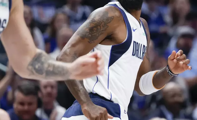 Dallas Mavericks guard Kyrie Irving, right, and guard Luka Doncic, left, run the court after Irving's made basket during the first half of an NBA basketball game against the Orlando Magic, Sunday, Nov. 3, 2024, in Dallas. (AP Photo/Gareth Patterson)