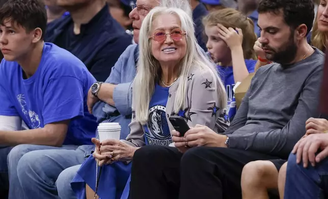 Dallas Mavericks owner Miriam Adelson, center, sits courtside during the second half of an NBA basketball game between the Mavericks and the Orlando Magic, Sunday, Nov. 3, 2024, in Dallas. (AP Photo/Gareth Patterson)