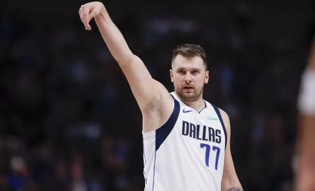 Dallas Mavericks guard Luka Doncic (77) celebrates after a 3-point basket during the first half of an NBA basketball game against the Orlando Magic, Sunday, Nov. 3, 2024, in Dallas. (AP Photo/Gareth Patterson)