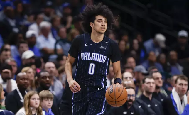 Orlando Magic guard Anthony Black (0) looks to pass the ball during the second half of an NBA basketball game against the Dallas Mavericks, Sunday, Nov. 3, 2024, in Dallas. (AP Photo/Gareth Patterson)