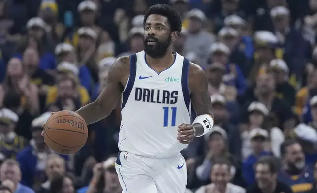 Dallas Mavericks guard Kyrie Irving (11) brings the ball up the court against the Golden State Warriors during the first half of an Emirates NBA Cup basketball game in San Francisco, Tuesday, Nov. 12, 2024. (AP Photo/Jeff Chiu)