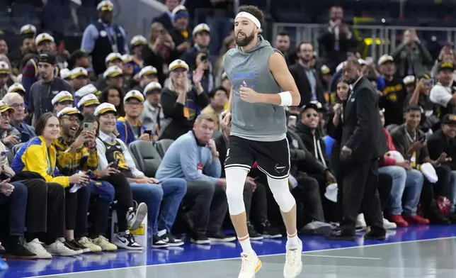 Fans cheer as Dallas Mavericks guard Klay Thompson jogs onto the court to warm up before an Emirates NBA Cup basketball game against the Golden State Warriors in San Francisco, Tuesday, Nov. 12, 2024. (AP Photo/Jeff Chiu)