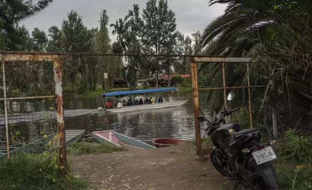 Amateur soccer players travel in a traditional canoe in the Xochimilco borough of Mexico City on Sunday, October 20, 2024. (AP Photo/Felix Marquez)