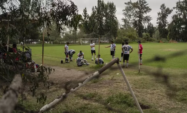 Amateur players take a break on a soccer field in the Xochimilco borough of Mexico City, Sunday, Oct. 20, 2024. (AP Photo/Felix Marquez)