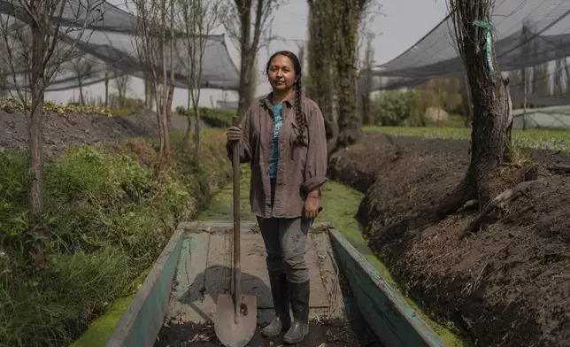 Cassandra Garduno poses for a portrait at her floating garden in the Xochimilco borough of Mexico City, Tuesday, Oct. 29, 2024. (AP Photo/Felix Marquez)