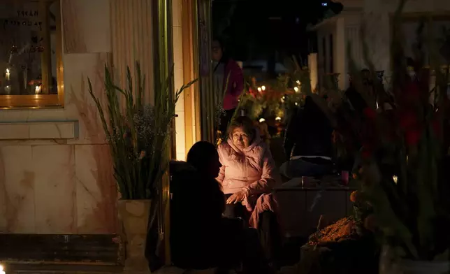 Families gather to keep company with their dearly departed, celebrating Day of the Dead, at the San Gregorio Atlapulco cemetery on the outskirts of Mexico City, Friday, Nov. 1, 2024. (AP Photo/Moises Castillo)