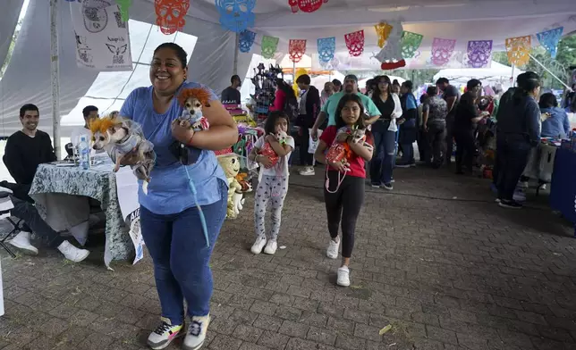 Contestants arrive to compete in a pet costume contest as part of the Day of the Dead festivities, in Mexico City, Sunday, Oct. 27, 2024. (AP Photo/Fabiola Sanchez)