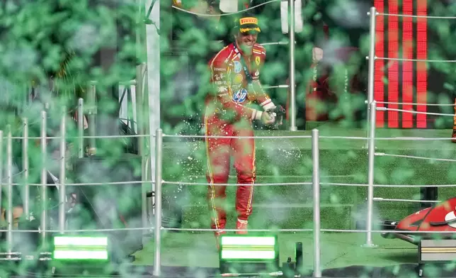 Ferrari driver Carlos Sainz of Spain celebrates after winning the Formula One Mexico Grand Prix auto race at the Hermanos Rodriguez racetrack in Mexico City, Sunday, Oct. 27, 2024. (AP Photo/Eduardo Verdugo)