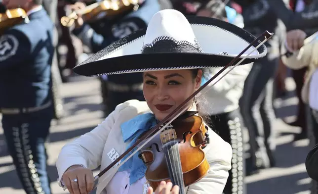 Musicians gather to break the record of most mariachis performing in unison, at the Zocalo, Mexico City's main square, Sunday, Nov. 10, 2024. (AP Photo/Ginnette Riquelme)