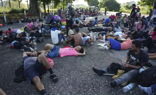 Migrants, who are part of a caravan heading toward the country's northern border and ultimately the United States, rest on the outskirts of Escuintla, southern Mexico, Thursday, Nov. 7, 2024. (AP Photo/Moises Castillo)