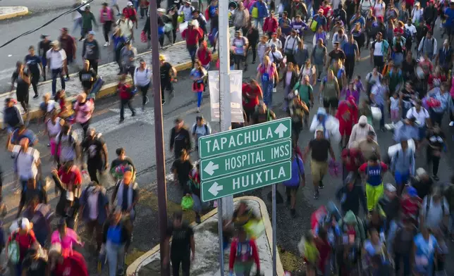 Migrants depart Tapachula, Mexico, hoping to reach the country's northern border and ultimately the United States, Tuesday, Nov. 5, 2024. (AP Photo/Moises Castillo)