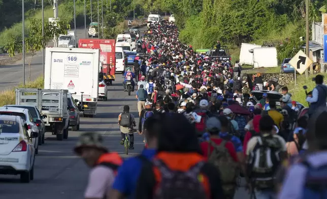 Migrants walk along the Huixtla highway after departing Tapachula, southern Mexico, hoping to reach the country's northern border and ultimately the United States, Tuesday, Nov. 5, 2024. (AP Photo/Moises Castillo)