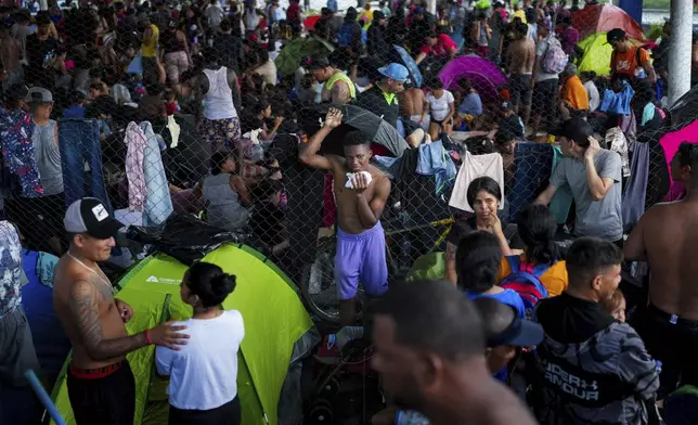 Migrants gather in a makeshift shelter in Huixtla, Chiapas state, Mexico, Wednesday, Nov. 6, 2024, hoping to reach the country's northern border and ultimately the United States. (AP Photo/Moises Castillo)