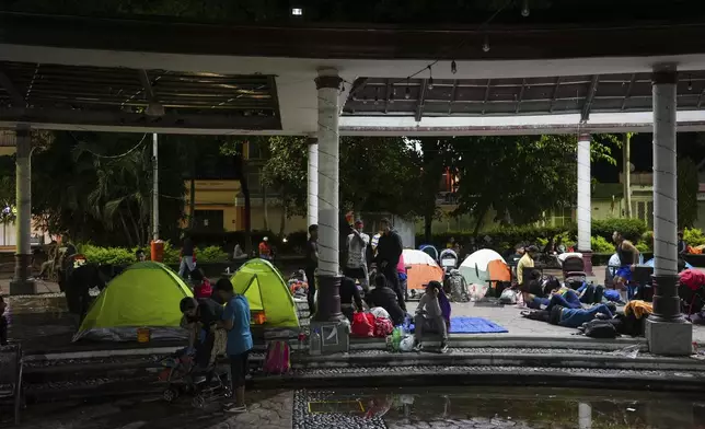 Migrants who are part of a caravan gather at Bicentenario Plaza in Tapachula, Mexico, Monday, Nov. 4, 2024, the night before departing by foot toward the U.S. border. (AP Photo/Moises Castillo)