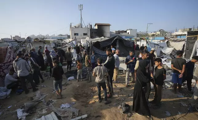 FILE - Palestinians gather at the site of an Israeli strike in the courtyard of the Al-Aqsa Hospital where displaced people live in tents, in Deir al-Balah, Gaza Strip, on Nov. 9, 2024. (AP Photo/Abdel Kareem Hana, File)