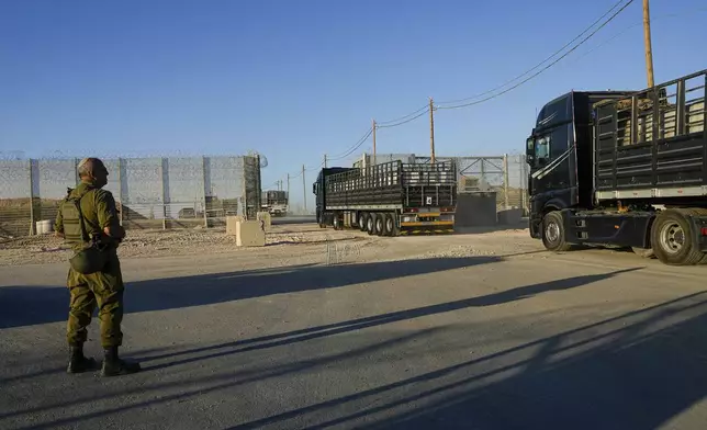 FILE - Trucks carrying humanitarian aid cross into the Gaza Strip from Erez crossing in southern Israel, on Oct. 21, 2024. (AP Photo/Tsafrir Abayov, File)