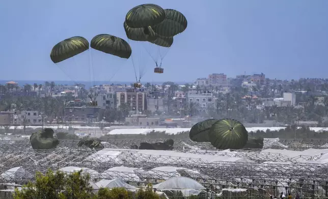 FILE - An aircraft airdrops humanitarian aid over Khan Younis, Gaza Strip, Thursday, May 30, 2024. (AP Photo/Abdel Kareem Hana, File)