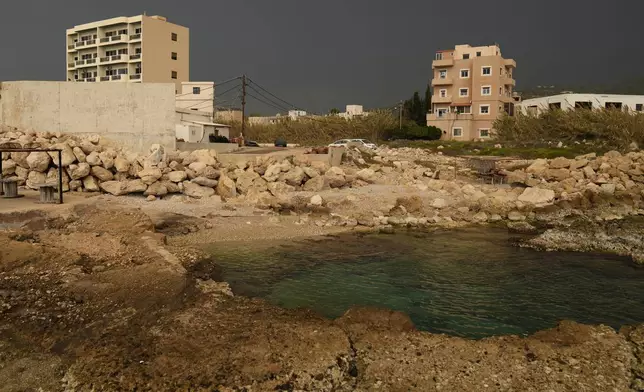 A building, left, in Batroun, northern Lebanon, Saturday, Nov. 2, 2024, where Lebanese officials say a ship captain was taken away by a group of armed men who landed on a coast north of Beirut and they're investigating whether Israel was involved. (AP Photo/Hussein Malla)