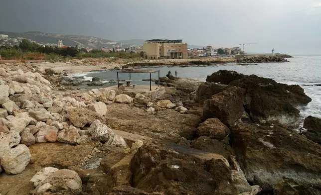 Lebanese fishermen cast their fishing rods at a beach in Batroun, northern Lebanon, Saturday, Nov. 2, 2024, where Lebanese officials say a ship captain was taken away by a group of armed men who landed on a coast north of Beirut and they're investigating whether Israel was involved. (AP Photo/Hussein Malla)