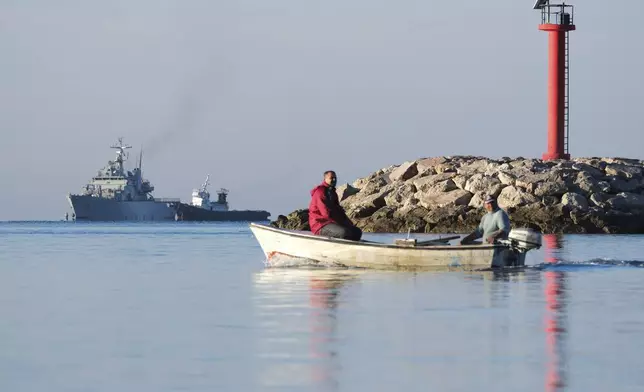 The Italian navy ship Libra, left, approaches the port of Shengjin, northwestern Albania, Friday, Nov. 8, 2024, with the second group of eight migrants intercepted in international waters to be processed there in a reception facility despite the failure with the first group in October. (AP Photo/Vlasov Sulaj)