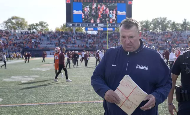 Illinois head coach Bret Bielema walks off the field after his team's 25-17 loss to Minnesota in an NCAA college football game Saturday, Nov. 2, 2024, in Champaign, Ill. (AP Photo/Charles Rex Arbogast)