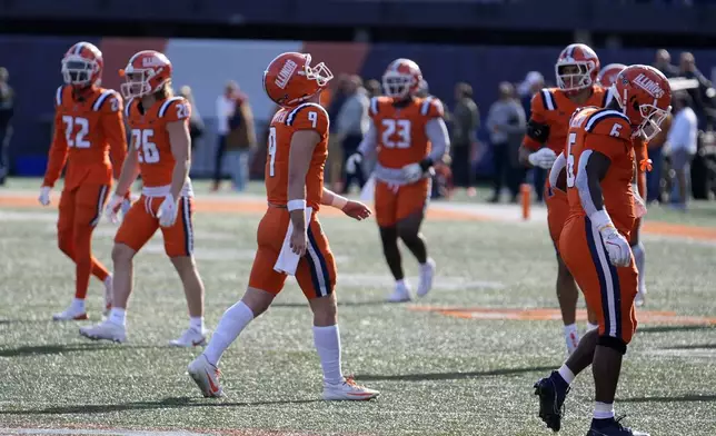 Illinois quarterback Luke Altmyer (9) walks off field after a fumble late in the fourth quarter of the team's 25-17 loss to Minnesota in an NCAA college football game Saturday, Nov. 2, 2024, in Champaign, Ill. (AP Photo/Charles Rex Arbogast)