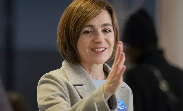 Moldova's President Maia Sandu smiles after casting her vote during a presidential election runoff, in Chisinau, Moldova, Sunday, Nov. 3, 2024. (AP Photo/Vadim Ghirda)