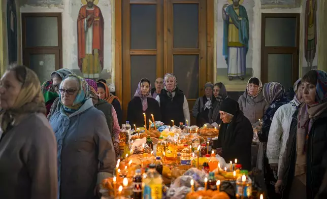 Women attend a religious service inside the Saint John the Baptist cathedral in Comrat, the capital of Gagauzia, an autonomous part of Moldova, Saturday, Nov. 2, 2024, ahead of a presidential election runoff taking place on Nov. 3. (AP Photo/Vadim Ghirda)