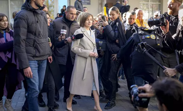 Moldova's President Maia Sandu speaks to the media after casting her vote during a presidential election runoff, in Chisinau, Moldova, Sunday, Nov. 3, 2024. (AP Photo/Vadim Ghirda)