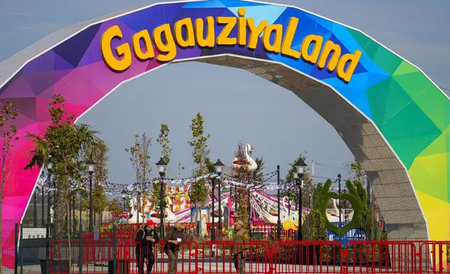 Security guards talk near the entrance of GagauziyaLand amusement park, in the village of Congraz, Gagauzia, an autonomous part of Moldova, Saturday, Nov. 2, 2024, ahead of a presidential election runoff taking place on Nov. 3. (AP Photo/Vadim Ghirda)