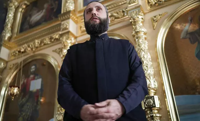 Father Vasilii speaks during an interview with the Associated Press at the Saint John the Baptist cathedral in Comrat, the capital of Gagauzia, an autonomous part of Moldova, Saturday, Nov. 2, 2024, ahead of a presidential election runoff taking place on Nov. 3. (AP Photo/Vadim Ghirda)