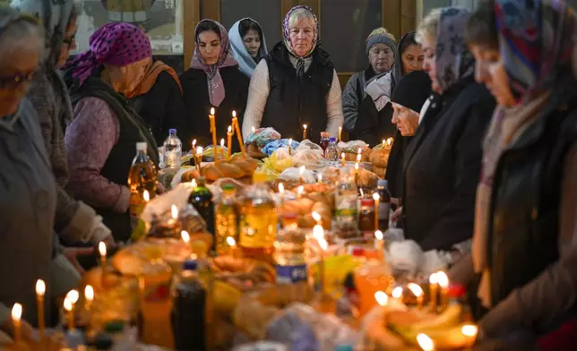 Women attend a religious service inside the Saint John the Baptist cathedral in Comrat, the capital of Gagauzia, an autonomous part of Moldova, Saturday, Nov. 2, 2024, ahead of a presidential election runoff taking place on Sunday. (AP Photo/Vadim Ghirda)