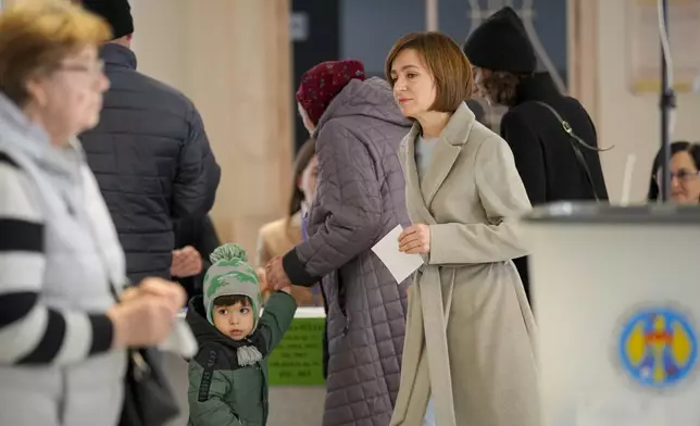 Moldova's President Maia Sandu arrives to cast her vote during a presidential election runoff, in Chisinau, Moldova, Sunday, Nov. 3, 2024. (AP Photo/Vadim Ghirda)