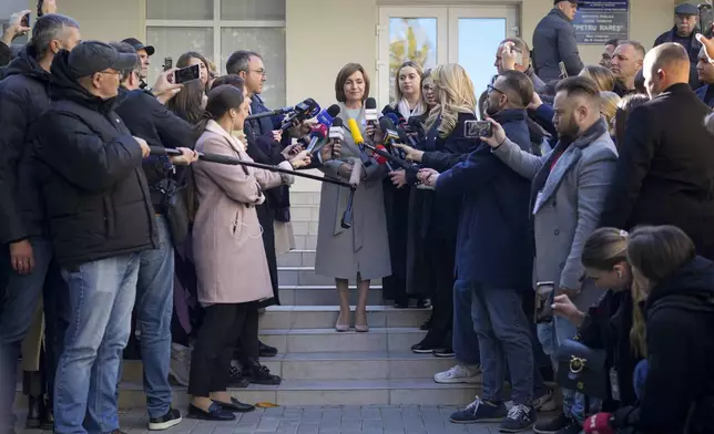 Moldova's President Maia Sandu speaks to the media after casting her vote during a presidential election runoff, in Chisinau, Moldova, Sunday, Nov. 3, 2024. (AP Photo/Vadim Ghirda)