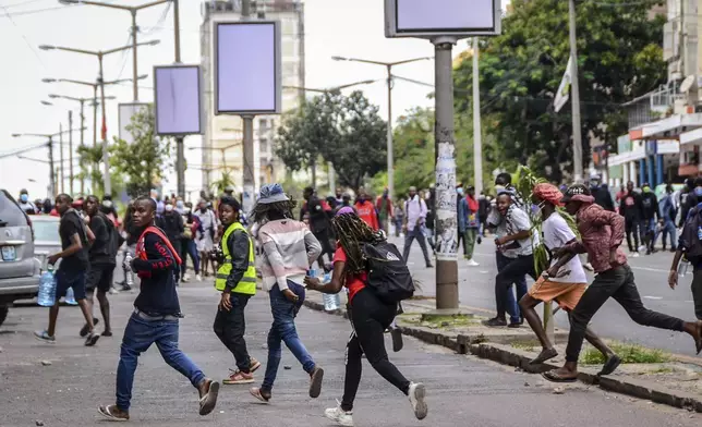 Protesters disperse as police deploy in Maputo, Mozambique, Thursday, Nov. 7, 2024. Protesters dispute the outcome of the Oct. 9 elections, which saw the ruling Frelimo party extend its 49-year rule. (AP Photo/Carlos Uqueio)