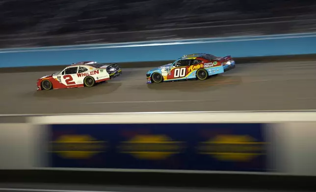 Jesse Love (2) and Cole Custer (00) drive during a NASCAR Xfinity Series auto race, Saturday, Nov. 9, 2024, in Avondale, Ariz. (AP Photo/John Locher)