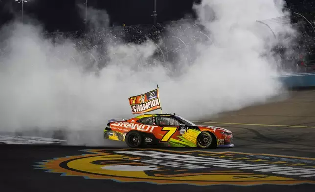 Justin Allgaier does a burnout after winning the championship after a NASCAR Xfinity Series auto race, Saturday, Nov. 9, 2024, in Avondale, Ariz. (AP Photo/John Locher)