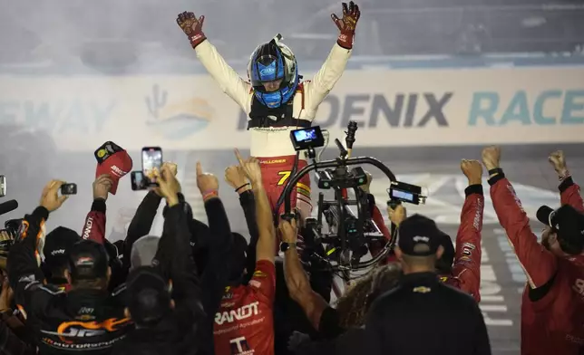 Justin Allgaier celebrates after winning the championship after a NASCAR Xfinity Series auto race, Saturday, Nov. 9, 2024, in Avondale, Ariz. (AP Photo/John Locher)