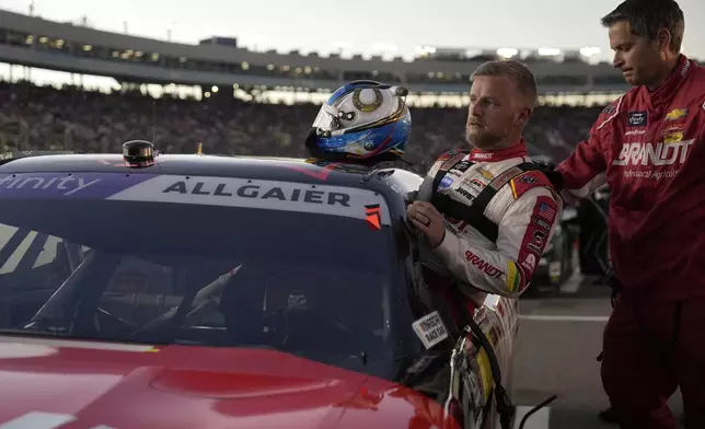 Justin Allgaier gets in his car before a NASCAR Xfinity Series auto race, Saturday, Nov. 9, 2024, in Avondale, Ariz. (AP Photo/John Locher)