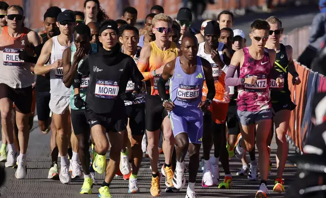 Yuma Morii, left, of Japan, makes his way onto the Verrazzano Narrows bridge with runners in the men's elite division make their way from the start line during the New York City Marathon, Sunday, Nov. 3, 2024, in New York. (AP Photo/Eduardo Munoz Alvarez)