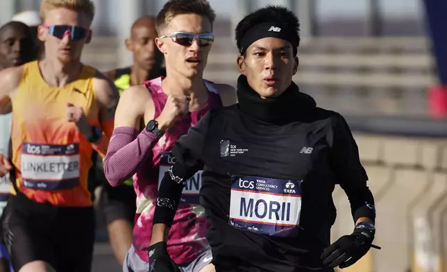 Yuma Morii, of Japan, right, makes his way across the Verrazzano Narrows bridge with the elite men's division runners during the New York City Marathon, Sunday, Nov. 3, 2024, in New York.(AP Photo/Eduardo Munoz Alvarez)