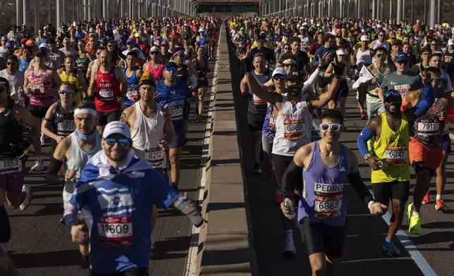 Runners cross the Verrazzano-Narrows Bridge at the start of the New York City Marathon, Sunday, Nov. 3, 2024, in New York. (AP Photo/Yuki Iwamura)